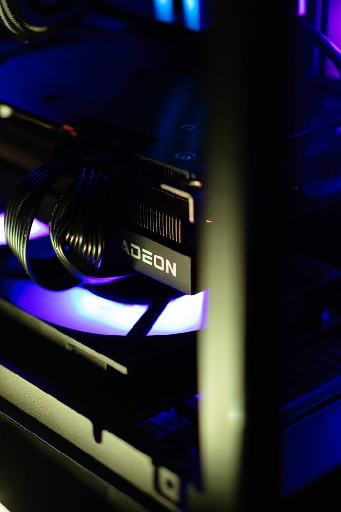 A detailed view of a custom-built gaming PC featuring a Radeon GPU with vibrant RGB lighting.